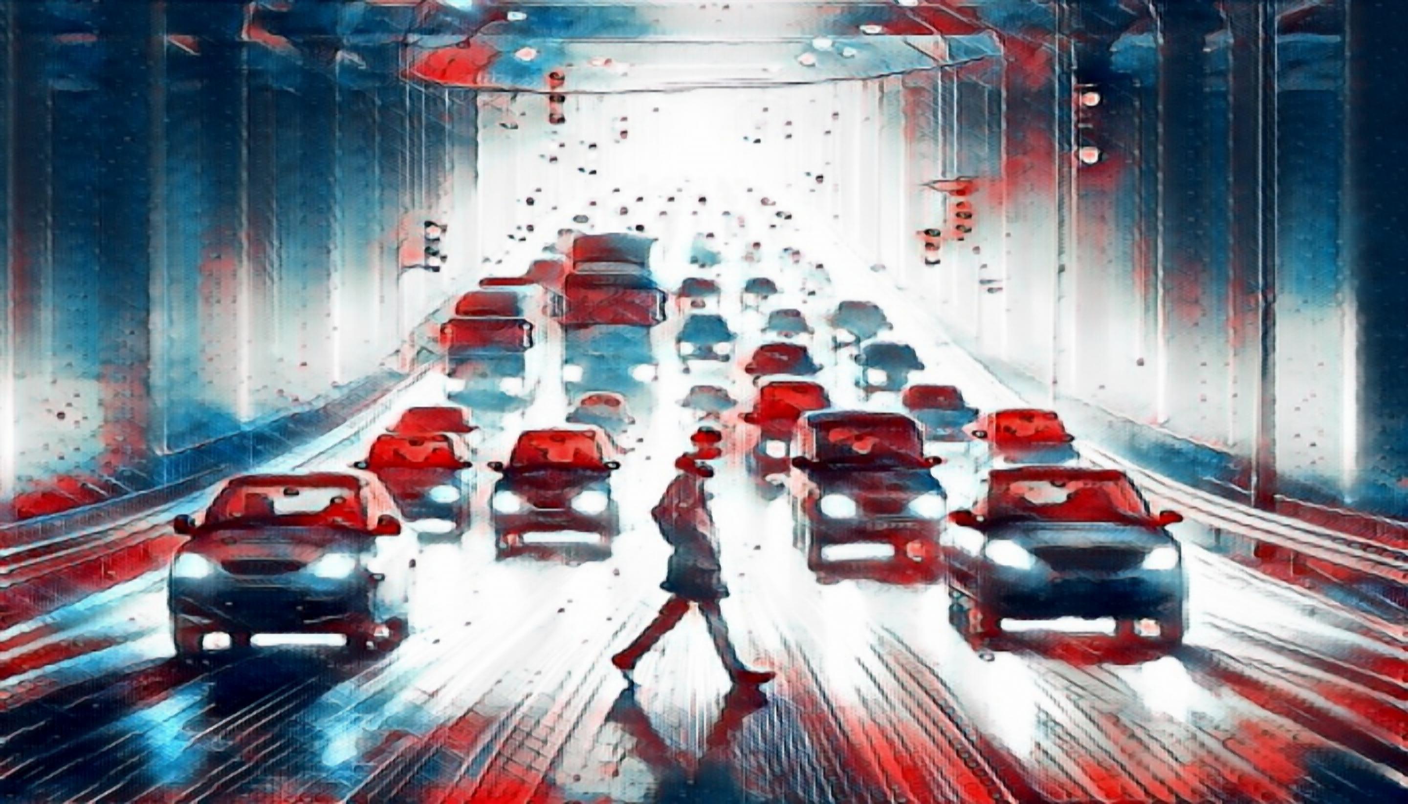 A pedestrian jaywalking on a highway through heavy traffic in California