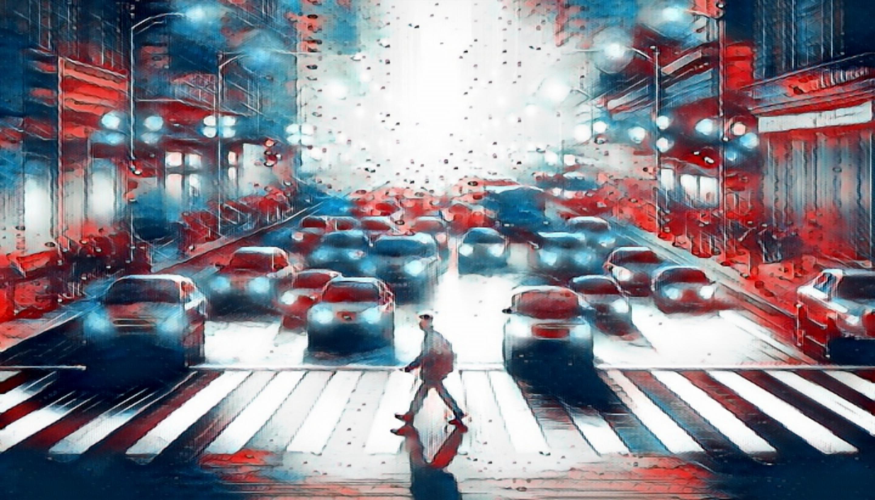 A pedestrian crossing a busy intersection in California